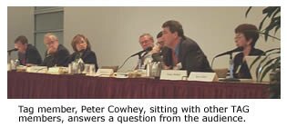 Tag member, Peter Cowhey, sitting with other TAG members, answers a question from the audience.
