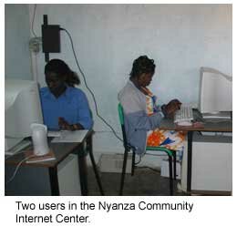 Two female users sitting at computers in the Nyanza community Internet center.