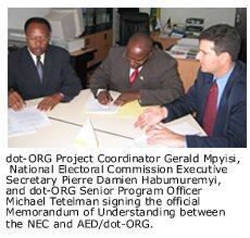 dot-ORG Project Coordinator Gerald Mpyisi, National Electoral Commission Executive Secretary Pierre Damien Habumuremyi, and dot-ORG Senior Program Officer Michael Tetelman signing the official Memorandum of Understanding between the NEC and AED/dot-ORG.