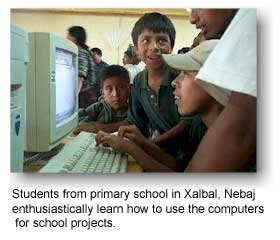 Image of students from primary school in Xalbal, Nebaj enthusiastically learn how to use the computers for school projects.