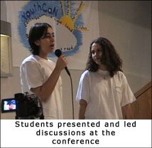 Photo of two students presenting and leading discussions at the conference.