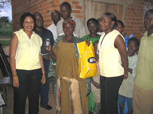 The 1000th Village Phone Operator, Topista Maidho, receiving her cell phone package