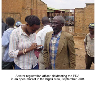 Voter registration officer fieldtesting PDAs in Kigali area