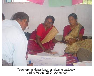Teachers review texbooks during August 2004 Workshop