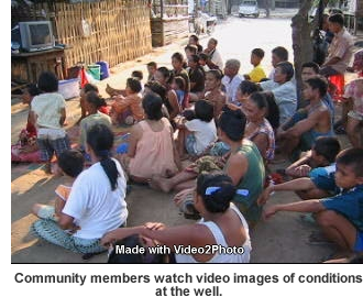 Dong Sak Community watching video images of well contamination issue